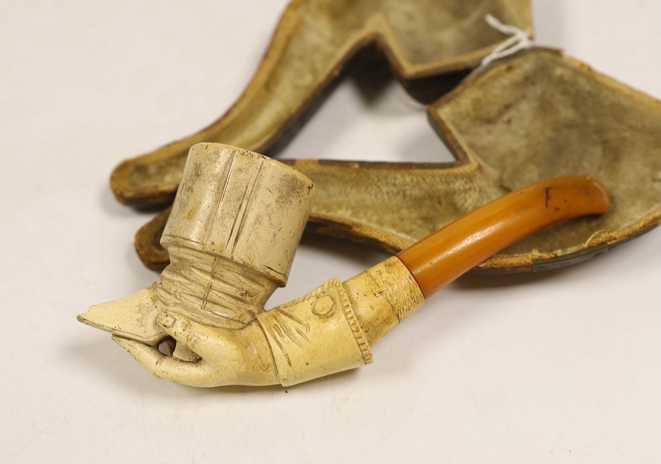 A cased Meerschaum smoker’s pipe in the form a boot and hand